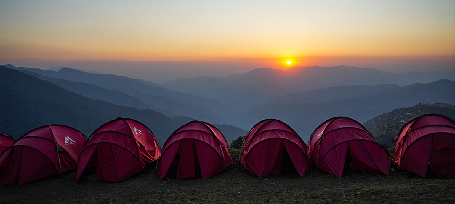 Sunset over tents on a ridge